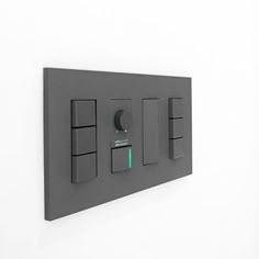 an electrical panel mounted to the side of a wall with three switches and two push buttons