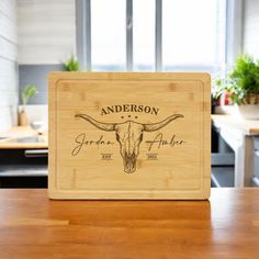 the personalized cutting board has an image of a steer's head on it