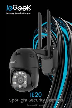 an image of a security camera with blue and black wires in the foreground, on a black background