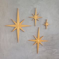 three gold stars on a gray wall