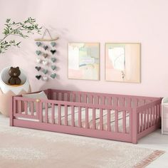 a baby's room with pink walls and white rugs on the floor next to a crib