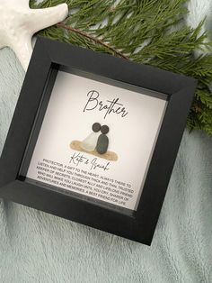 a black frame with a couple's wedding date on it next to a starfish