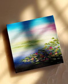 a painting on a canvas with water lilies