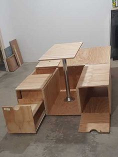 an unfinished wooden table and chair in a room