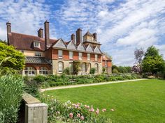 a large brick house with many windows and chimneys