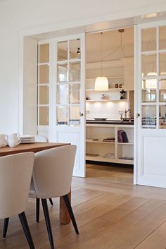 the dining room table is set with four chairs, and there are no people around it