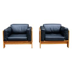 two black leather chairs sitting next to each other