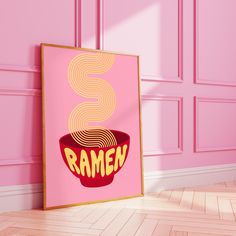 a pink room with a framed poster on the wall that says ramen in front of it