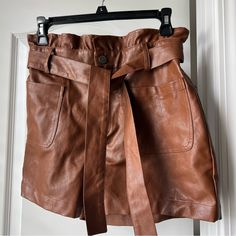 Brown Faux Leather High Waisted Shorts With Tie At The Waist. Brand Is Alya, But I Think It Was Purchased At Francesca’s - Size Medium. New Without Tags - From A Non-Smoking But Pet Friendly Household Chic Brown Belted Bottoms, Brown Faux Leather Bottoms With Belt Loops, Faux Leather Mini Skirt With Pockets, High Waist Brown Shorts With Belt Loops, Brown High Waist Shorts With Belt Loops, High Waist Faux Leather Shorts With Pockets, Chic Brown Paperbag Waist Bottoms, Faux Leather Short Bottoms For Day Out, Chic Brown Shorts With Belt Loops