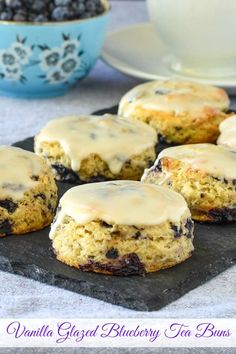 blueberry muffins with glazed blackberry tea buns on a plate