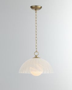 a light that is hanging from a chain on the ceiling with a white wall in the background