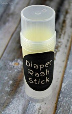 a tube of diaper rash stick sitting on top of a wooden table