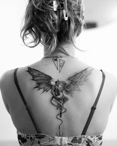 a woman with a tattoo on her back