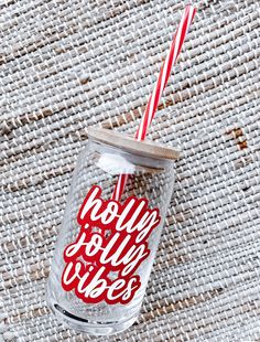 a red and white straw in a clear glass with the words hello dolly wees on it