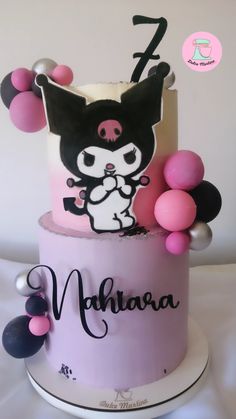 a pink and white cake with an image of a cat on it's top