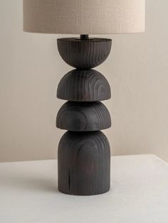 a lamp that is sitting on top of a white table next to a black object