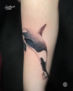 an orca whale tattoo on the arm