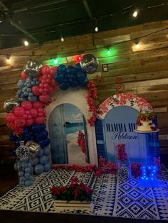 the balloon arch is decorated with red, white and blue balloons