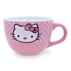 a pink hello kitty coffee cup with polka dots