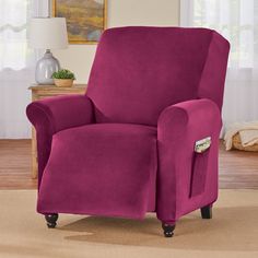 a living room with a purple recliner chair in the corner and a lamp on the side table