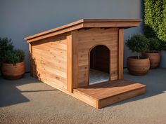 a wooden dog house sitting on top of a cement ground next to potted plants