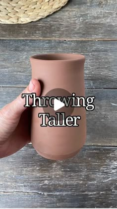 a hand holding a brown cup with the words throwing taller in front of it