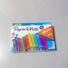 a package of paper mate ink -joy pens sitting on top of a white table