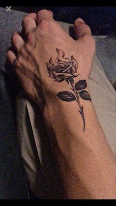 a person's foot with a rose tattoo on it