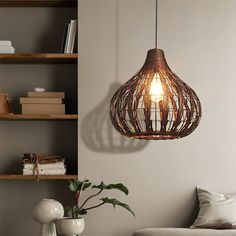 a living room filled with furniture and a lamp hanging over the top of a table