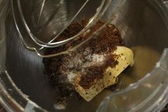 a metal bowl filled with brown and white food