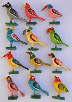 many colorful birds sitting on top of each other