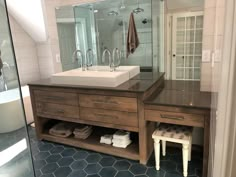 a bathroom with two sinks and a large mirror