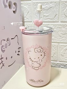 a hello kitty cup with a straw sticking out of it