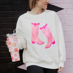 Step into style with our Kicking Boots Western Sweatshirt, now available at wholesale prices! This charming design features two vibrant pink boots kicking up some fun. Crafted with quality and comfort in mind, this sweatshirt is perfect for adding a touch of Western flair to your boutique's collection. Whether your customers are hitting the town or relaxing at home, this sweatshirt is sure to make a statement. Stock up on this trendy favorite and delight your customers with the Kicking Boots Wes Wholesale Sweatshirts, Pink Cowboy Boots, Western Sweatshirts, Tie Dye Hat, Pink Cowboy, Towel Scarf, Blank Hats, Boots Western, Pink Boots