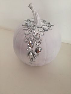 a white pumpkin decorated with crystal jewels