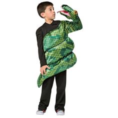 a young boy in a green costume holding an alligator's tail up to his face