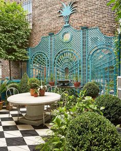 an outdoor dining area with potted plants