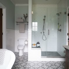 a bathroom with a shower, toilet and bathtub next to a sink in it