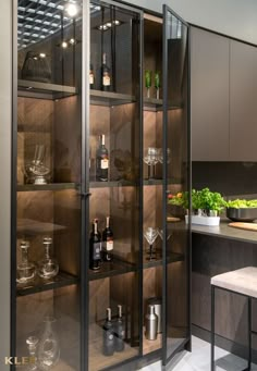 a kitchen with glass shelves filled with bottles and glasses