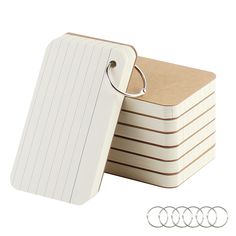 a stack of white luggage tags with two rings on each side and three smaller ones in the middle