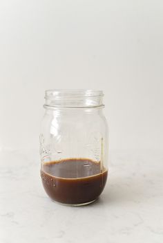 a glass jar filled with liquid sitting on top of a counter