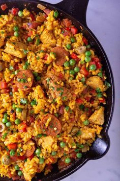 a skillet filled with rice and peas