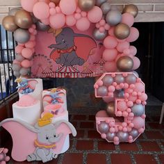 an elephant themed birthday party with balloons and decorations for the number 5, balloon arch