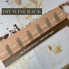 a wooden wine rack sitting on top of a dirty floor