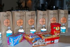 several bags with different types of snacks on them sitting on a counter top next to boxes