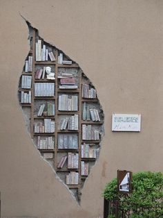 a book shelf with books on it is shown in the shape of a broken wall