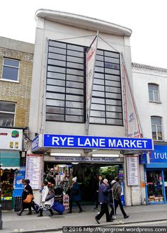 people are walking in front of the rye lane market