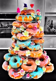 a large stack of doughnuts sitting on top of each other in a kitchen