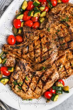 grilled steaks and vegetables on a white plate