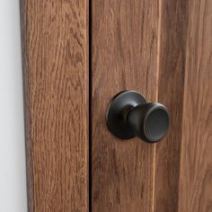 a wooden cabinet with two knobs on it